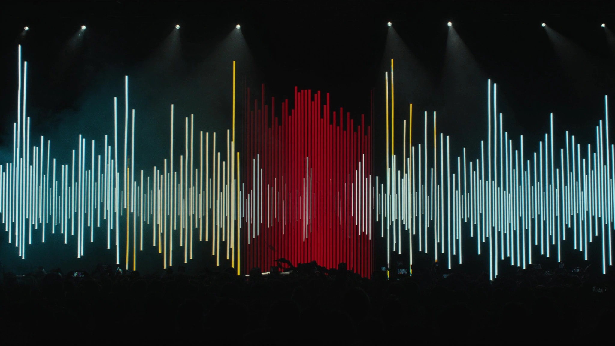 Concert stage translated into a field of luminous amplitude bars.