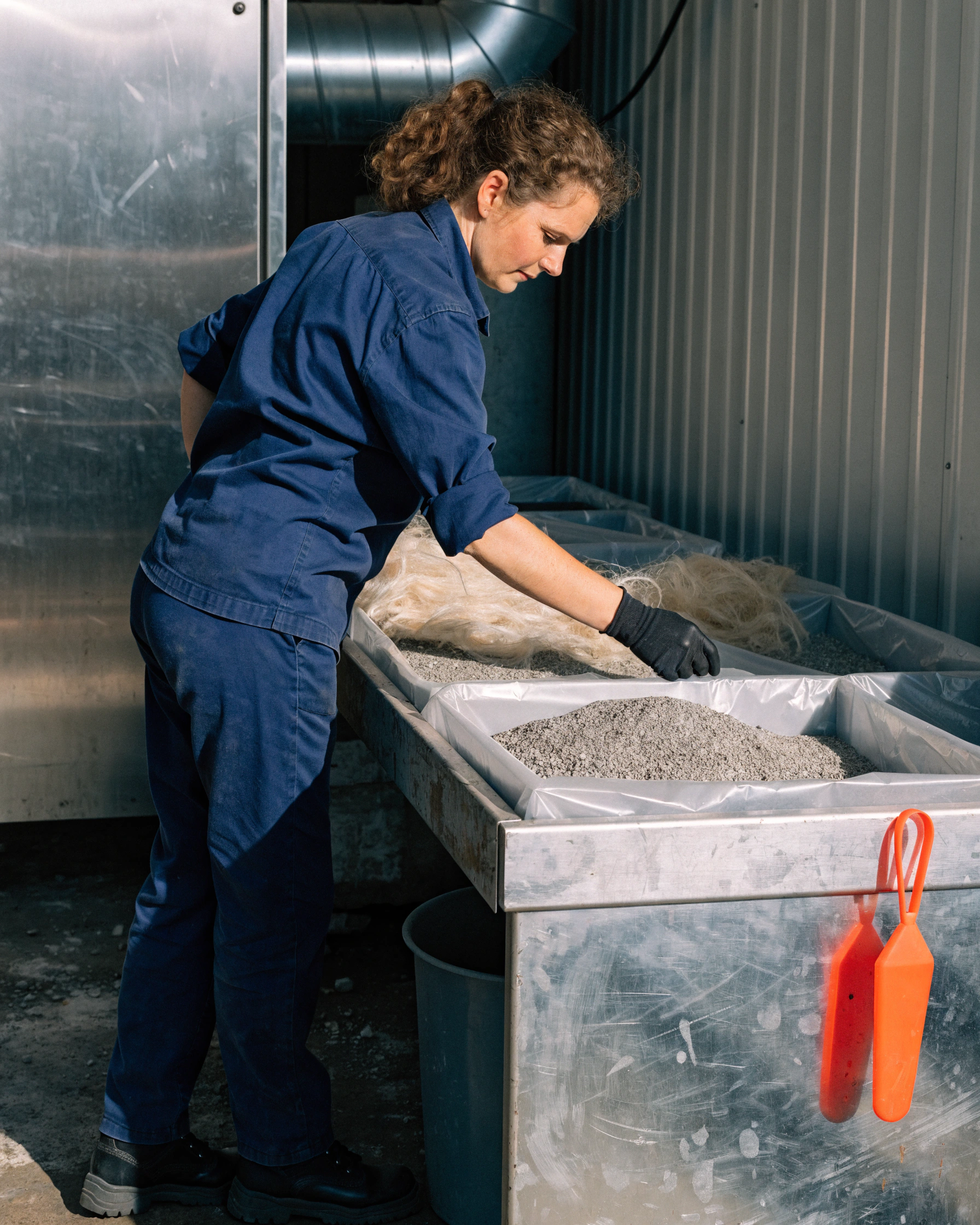 Mineral by-product and fibre are weighed before entering a cold press.