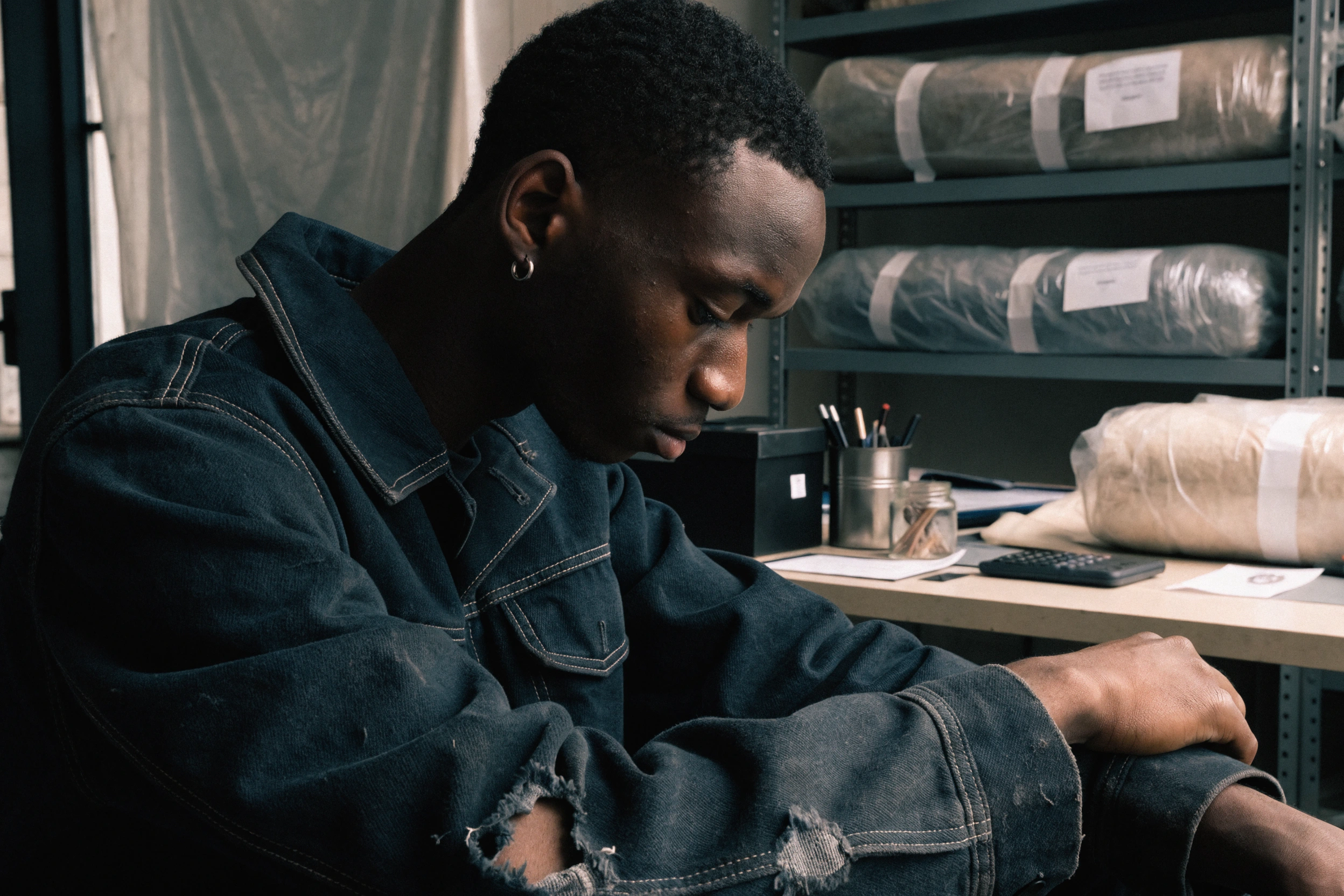A torn elbow and stressed seam are documented on the wearer before repair.