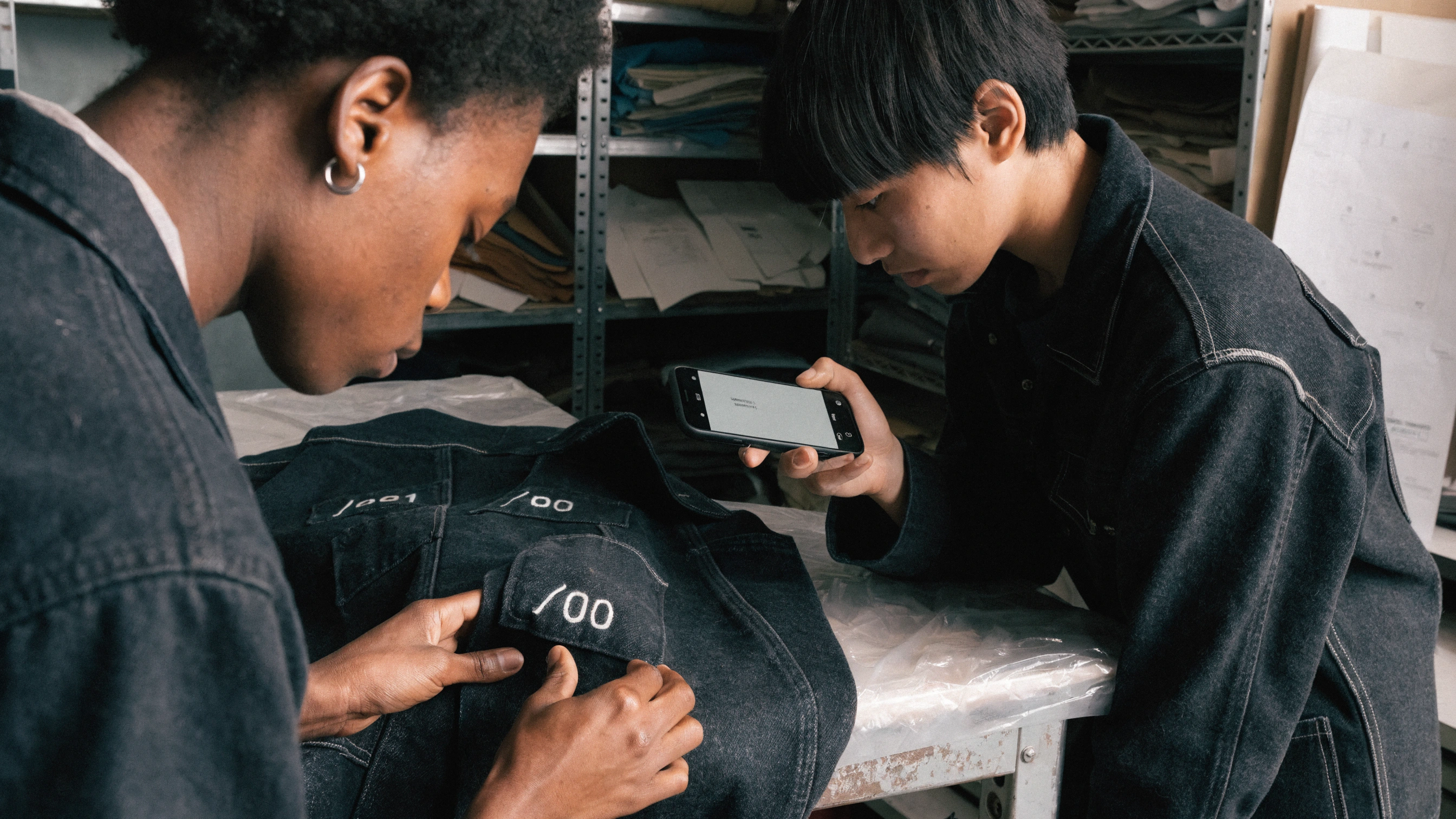 A second wearer scans the passport while every earlier seam remains visible.