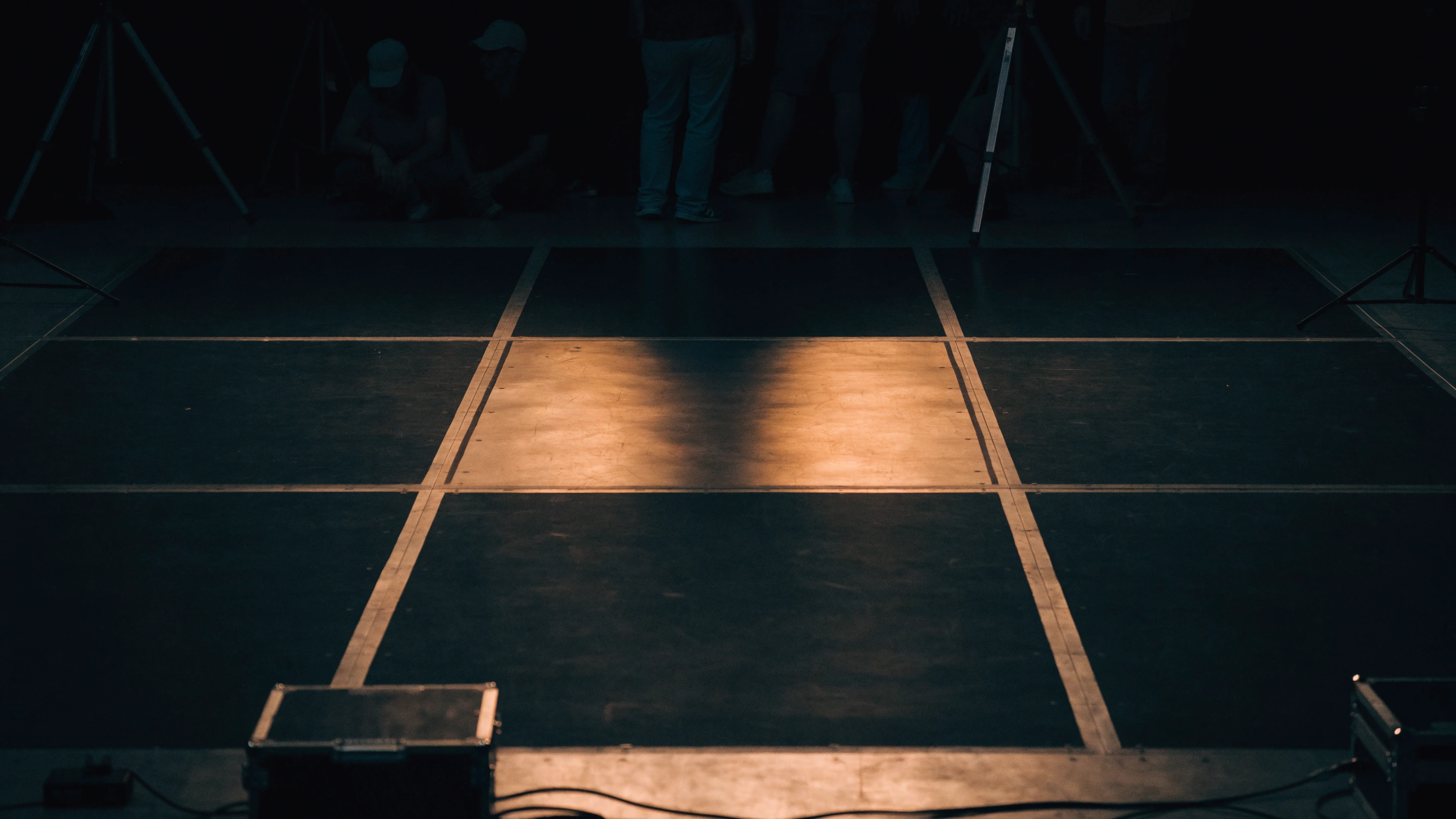 The post-show stage is empty except for one illuminated central tile.